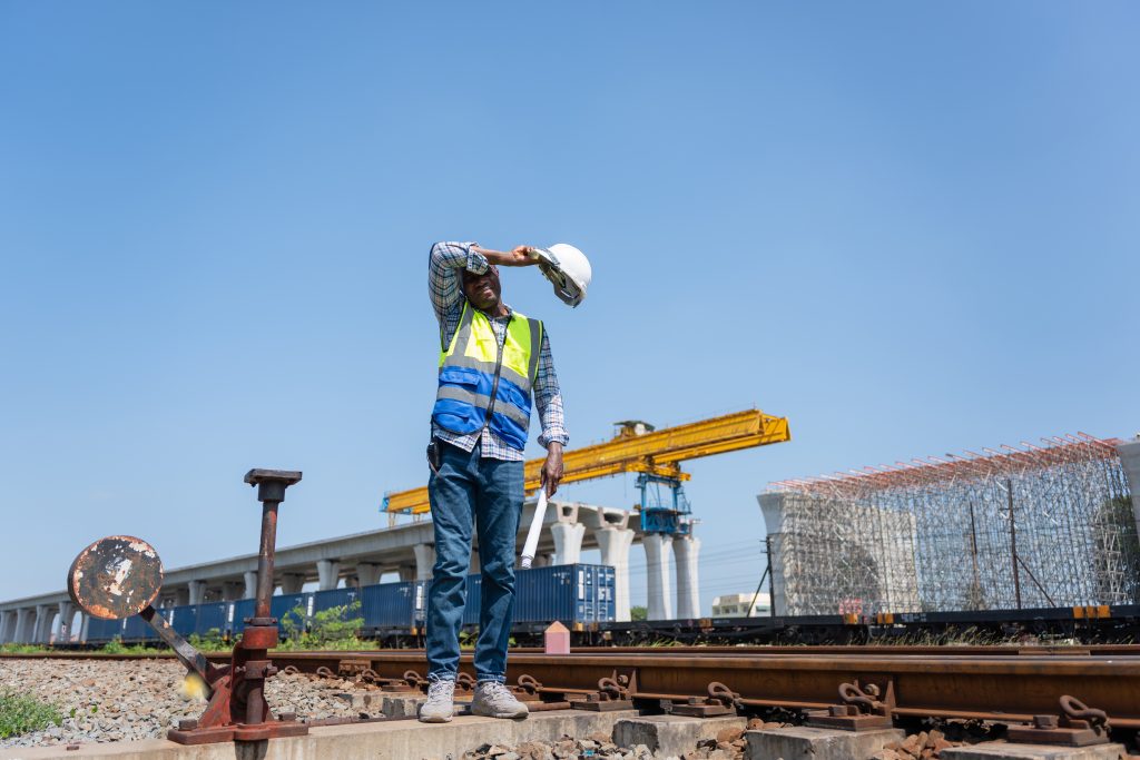 Construction Worker Shielding Eyes from Sun